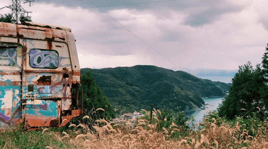 And abandoned bus with graffiti in the inaka countryside of rural Shikoku, japan